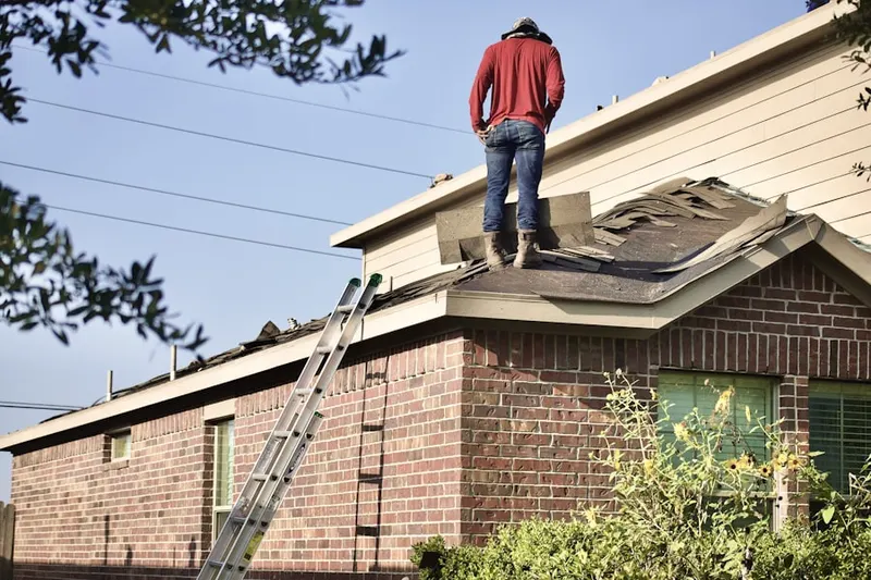 Professional roofer working on a residential roof in West Whittier